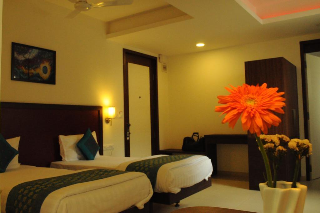 Ixora Suites Bengaluru Szoba fotó